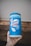 A container of Lysol Advanced disinfecting wipes is held by a hand wearing a glove. The container is predominantly blue and white, featuring labels that emphasize its disinfecting power and ability to kill viruses and bacteria.