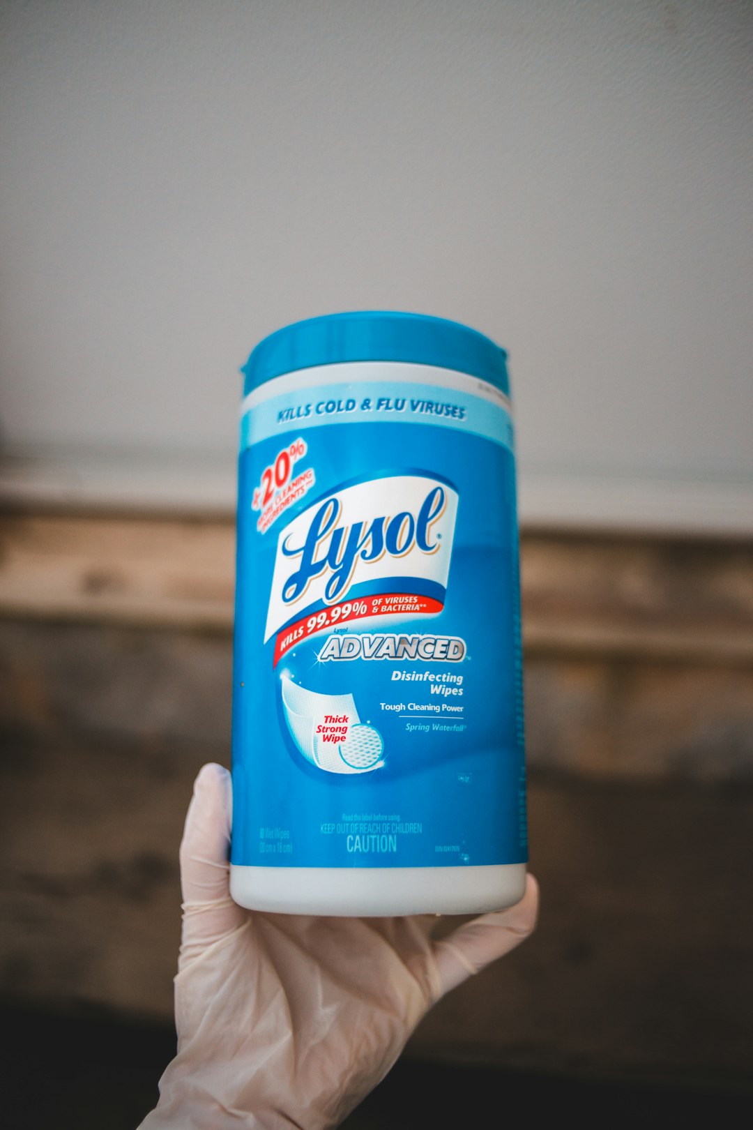 person holding white and blue plastic bottle