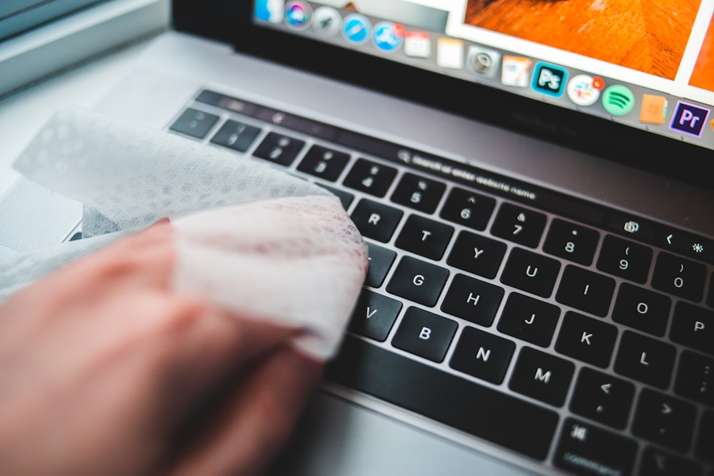 persons finger on macbook pro