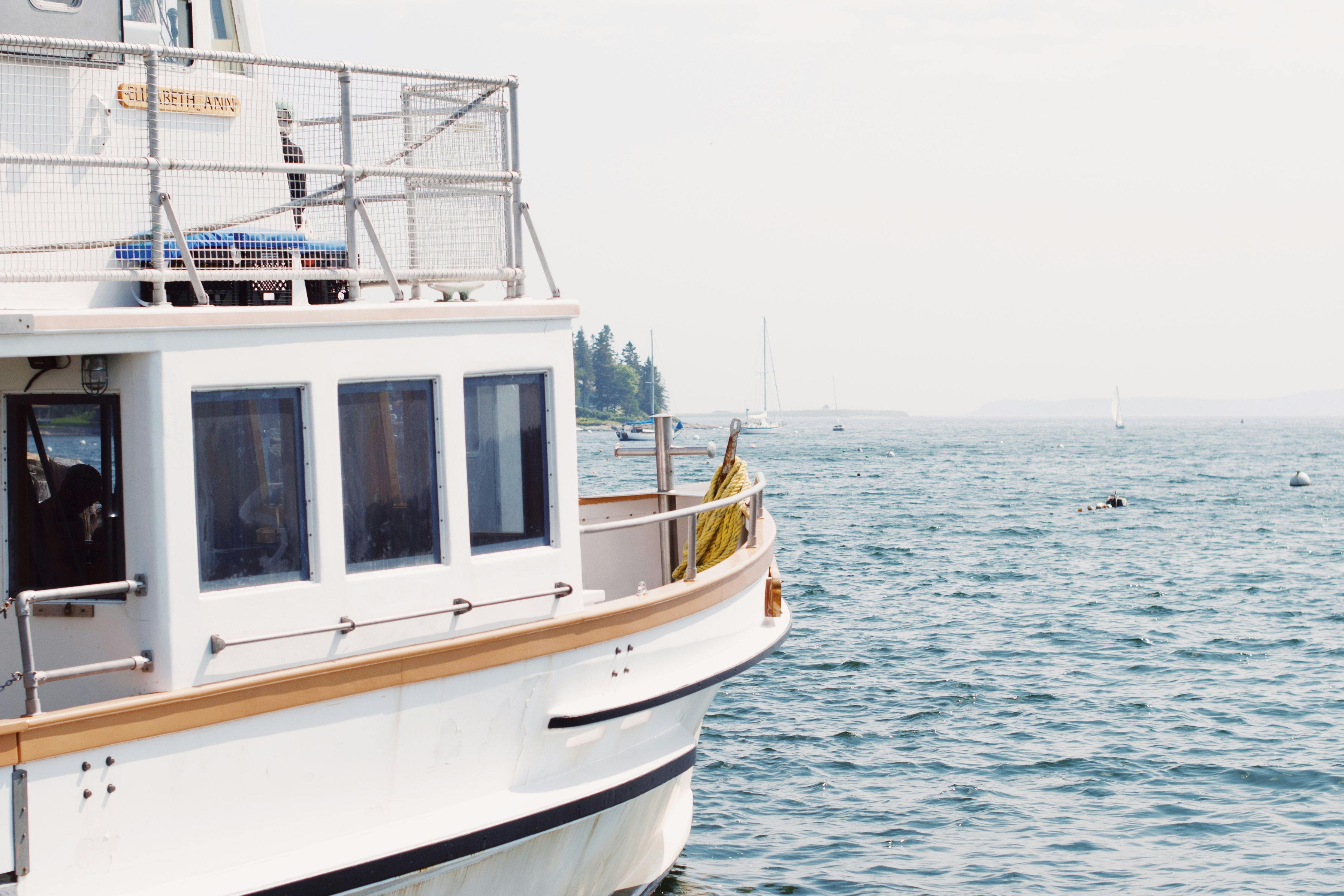 white and brown boat on sea during daytime