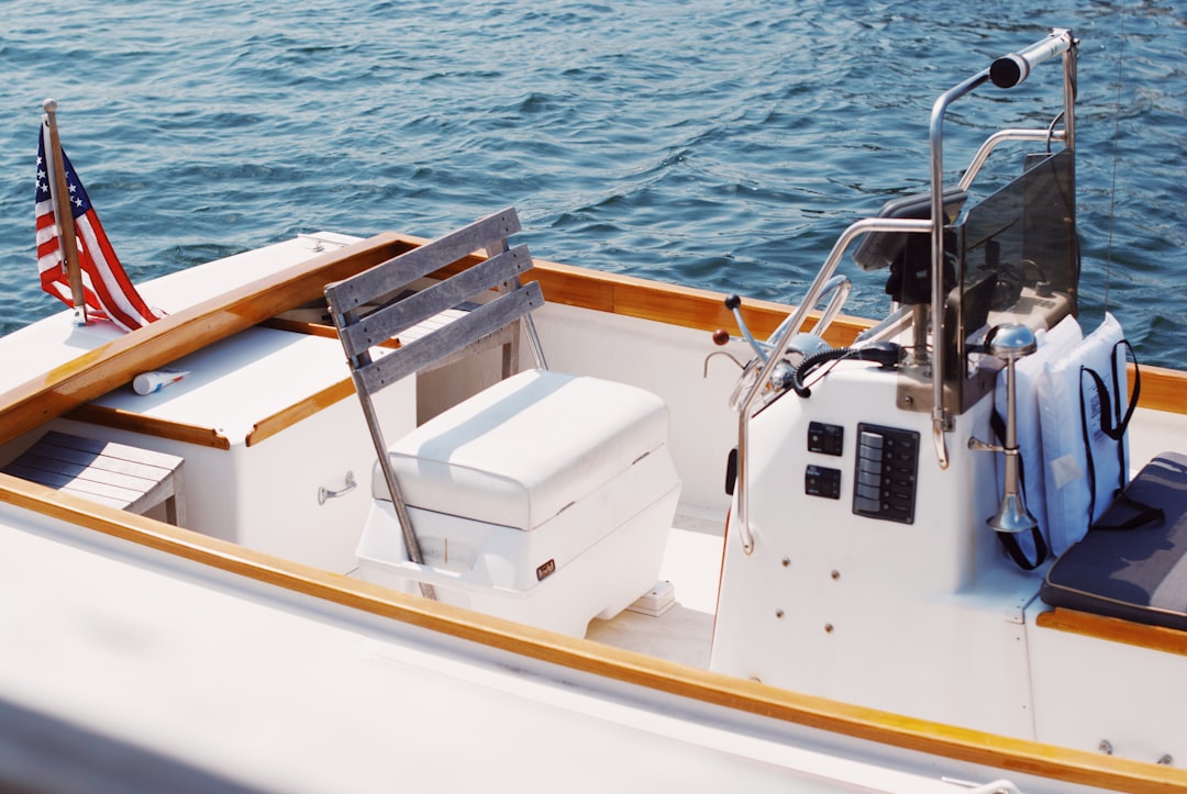 white and brown boat on sea during daytime, Boat in Maine with an American flag<p></figure>