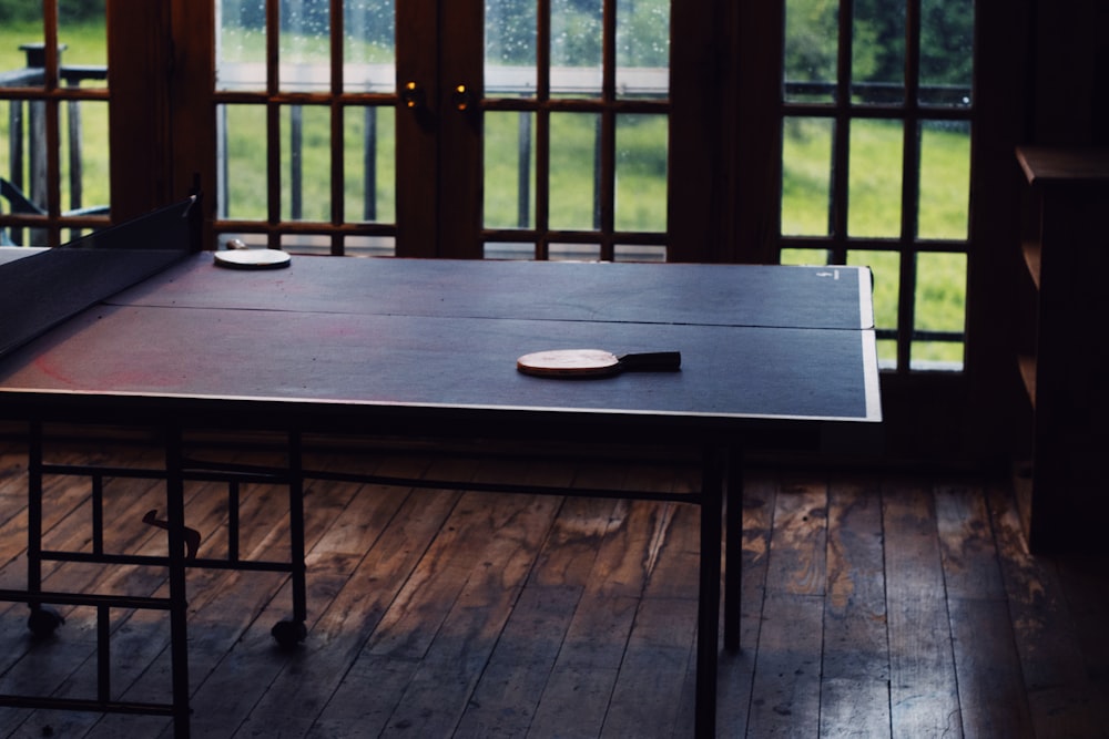 brown wooden table with white ceramic plate on top