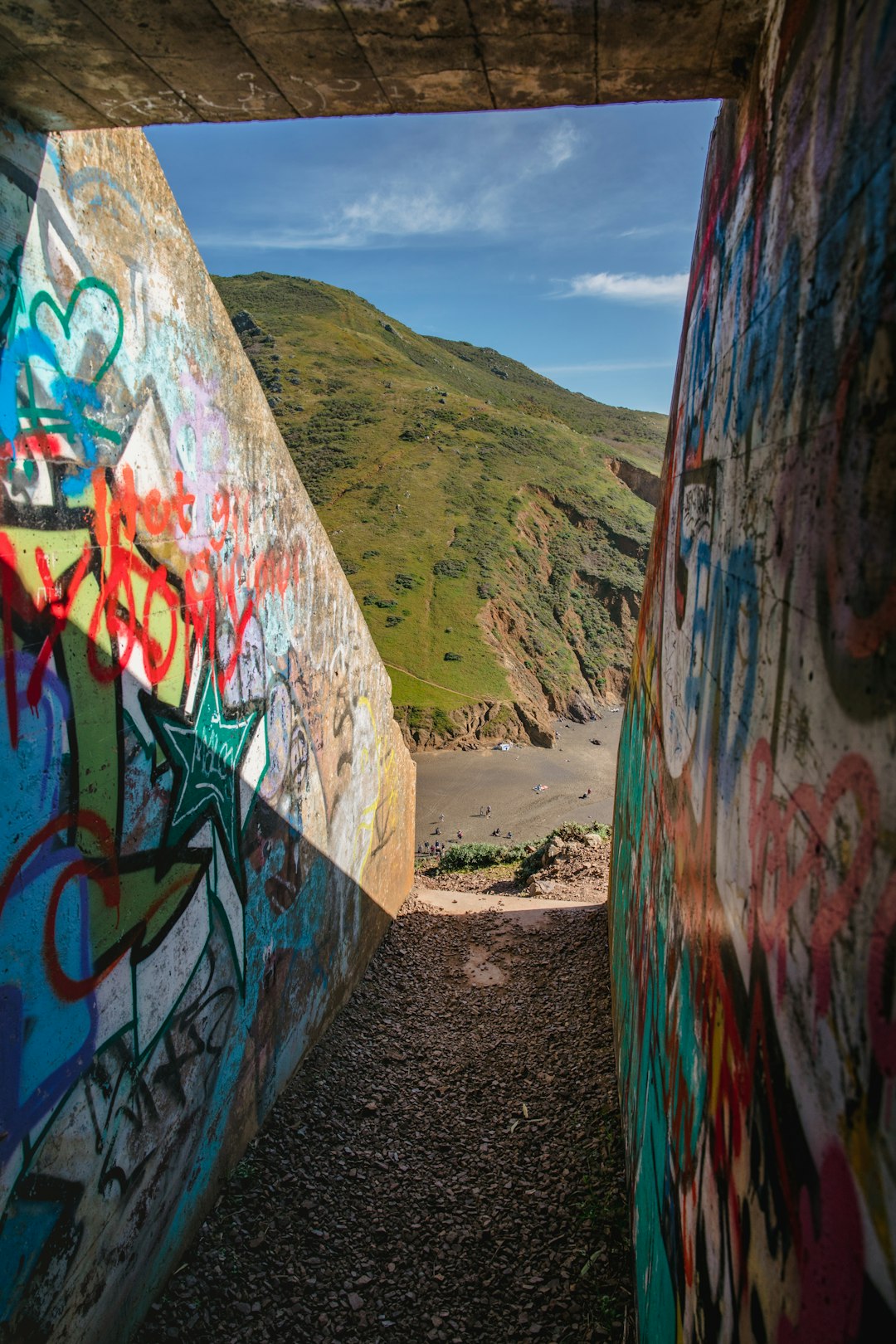 graffiti on wall near body of water during daytime