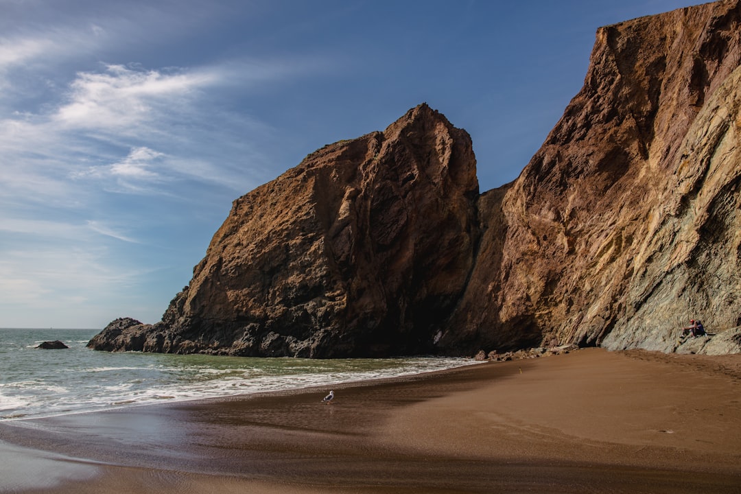 brown rock formation on sea shore during daytime