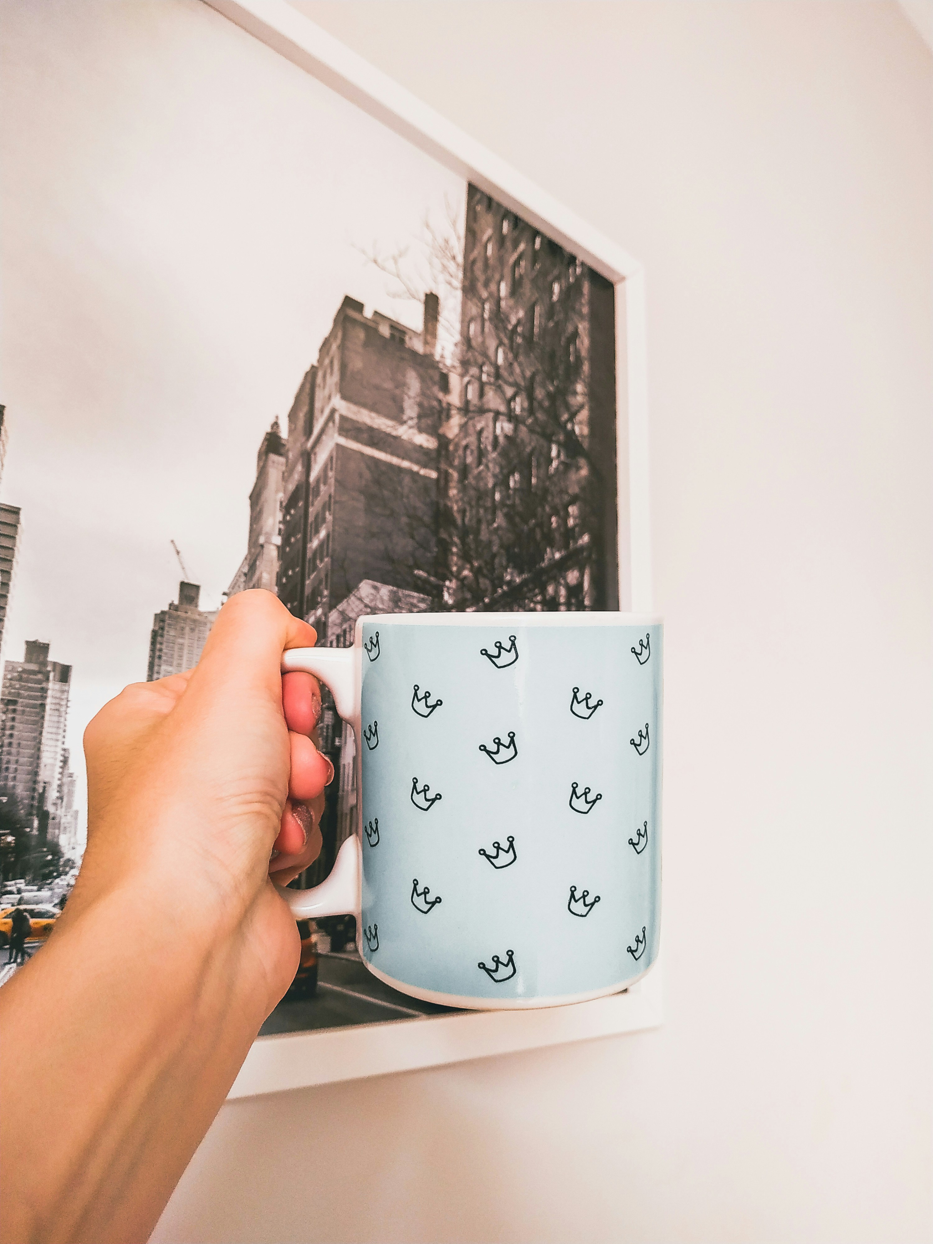 person holding white ceramic mug