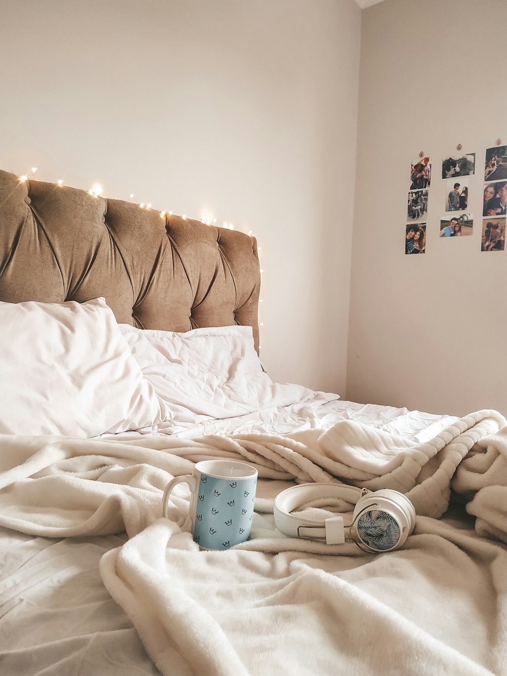 white and blue polka dot ceramic mug on white bed linen