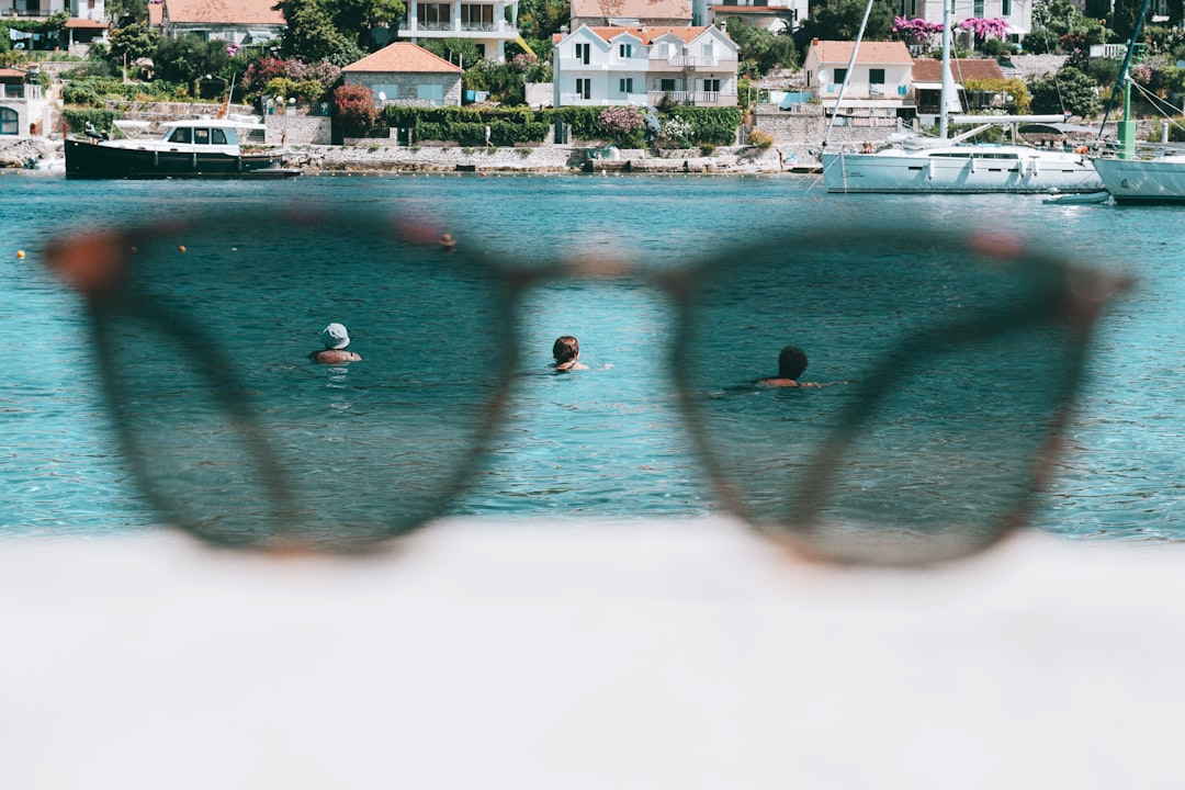 people swimming on sea during daytime