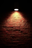 Evening photo of a completed brick wall with warm lighting highlighting textures