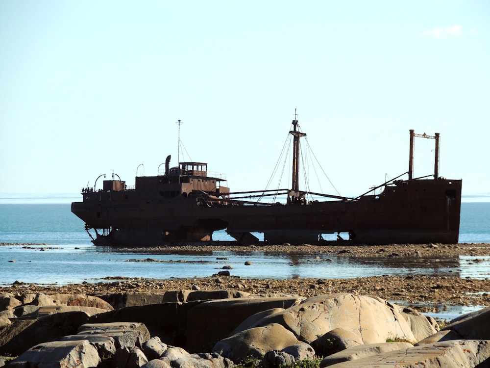 black ship on sea during daytime