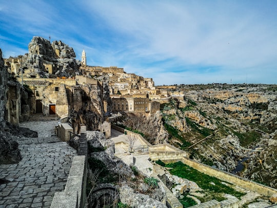 brown concrete building under blue sky during daytime in Sassi di Matera Italy