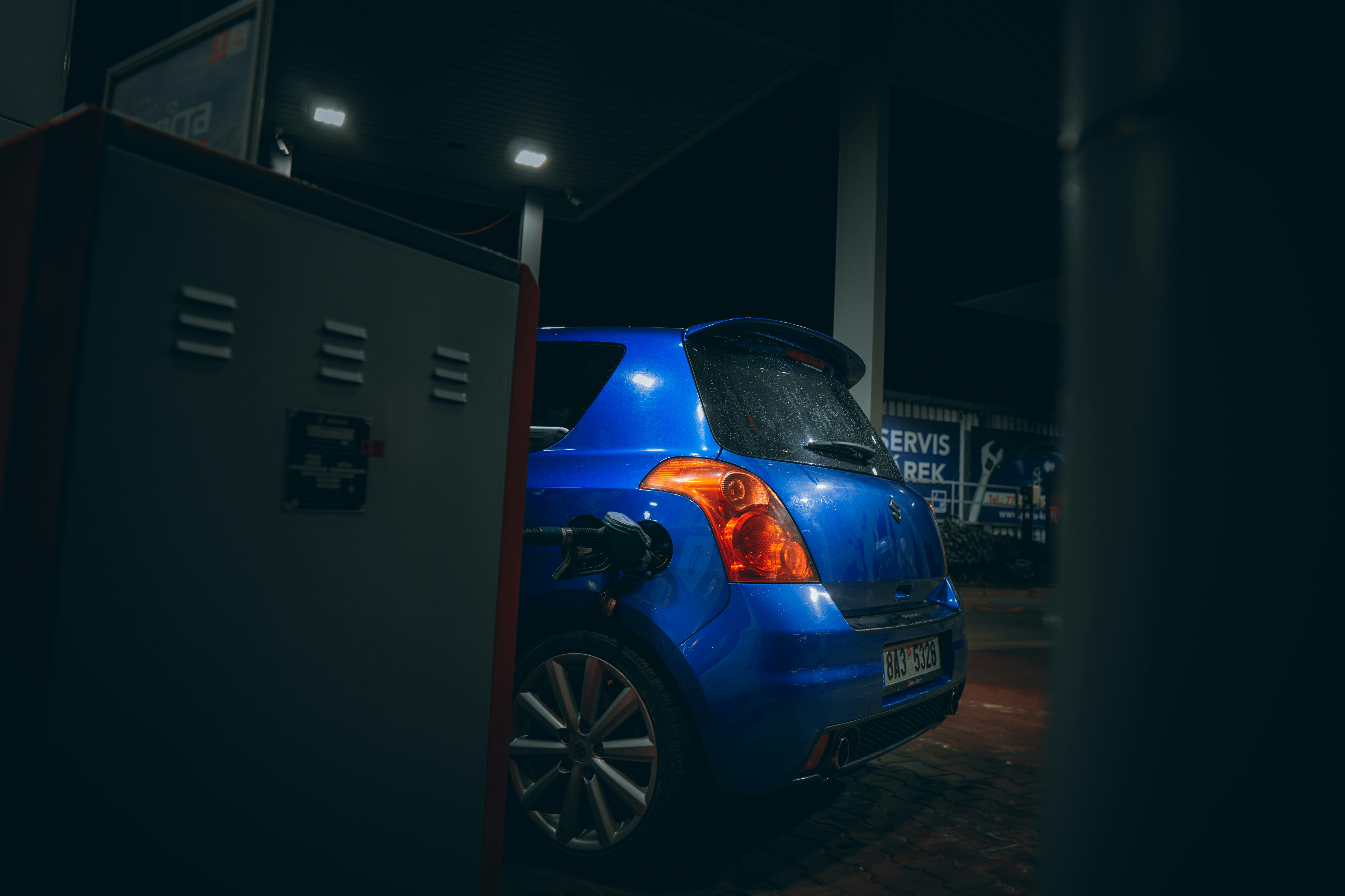 blue car parked near building