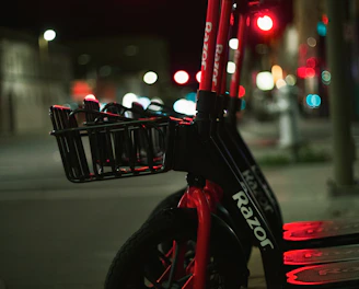 A sleek electric scooter parked on a city street at sunset
