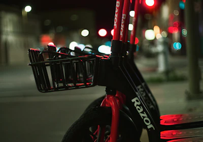 A sleek electric scooter parked on a city street at sunset
