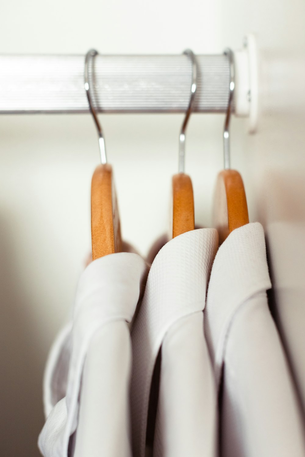 white and brown clothes hanger