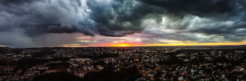 city with high rise buildings under gray clouds during daytime