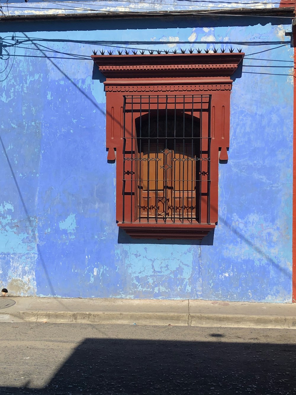 brown wooden door on blue concrete wall