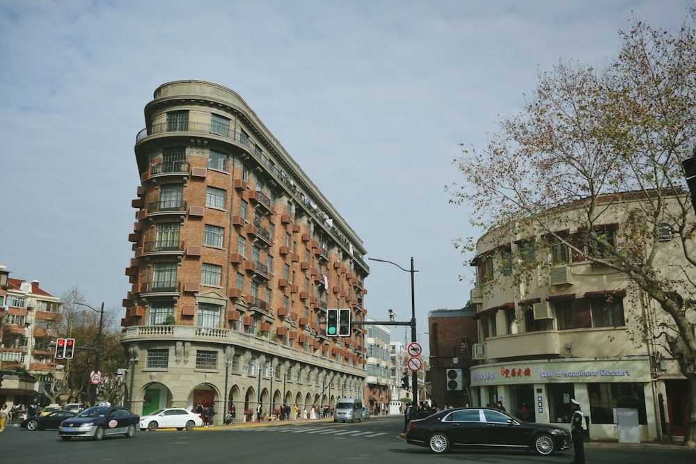 cars parked beside brown concrete building during daytime