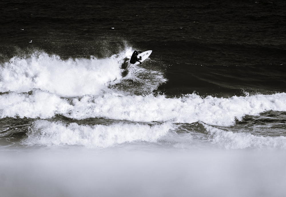 person surfing on sea waves during daytime