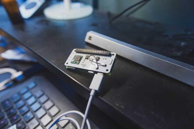 A focused engineer working on a sleek computer circuit board in a modern workspace.