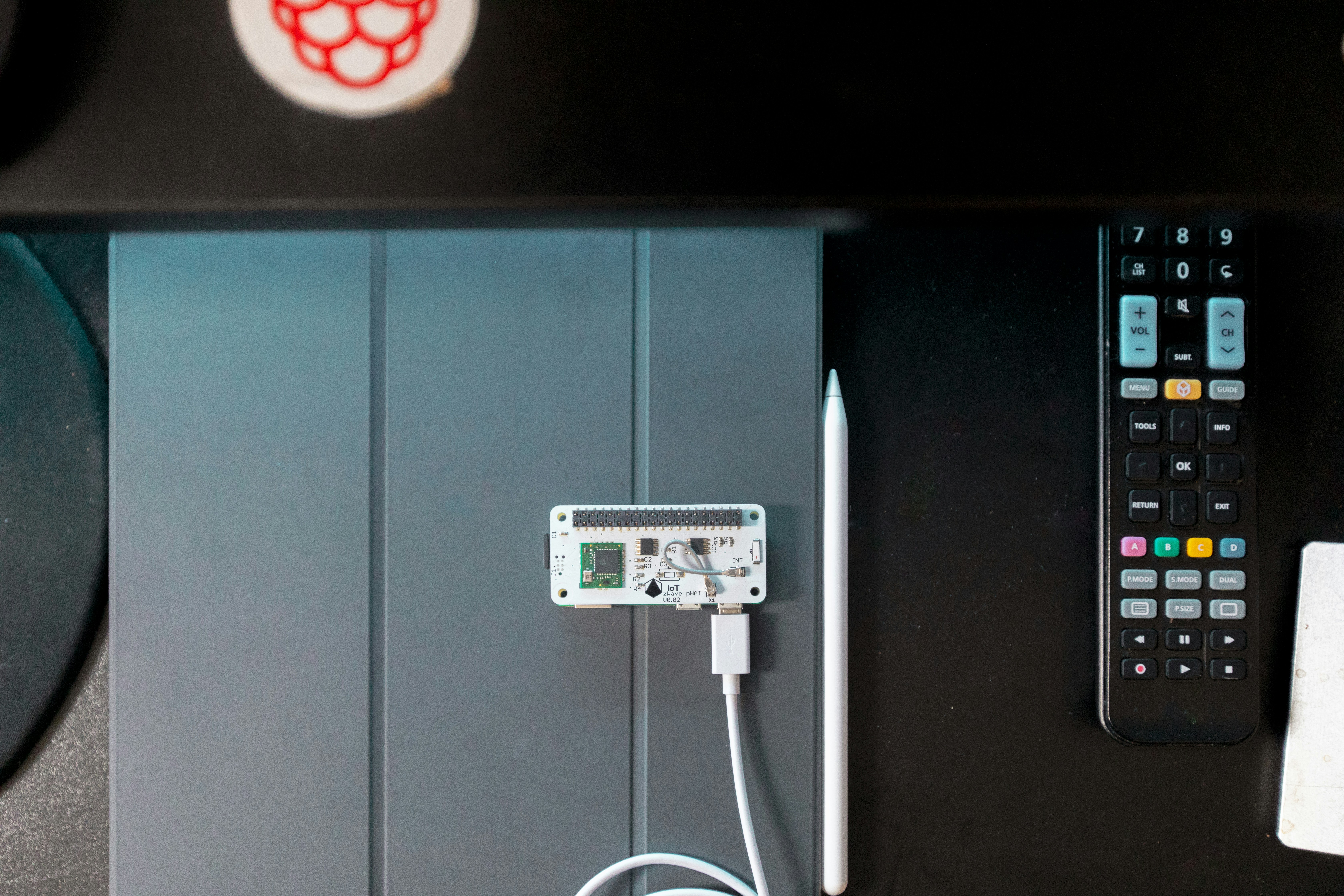 Comparison of a small Wi-Fi hub next to a full smart garage door opener unit - smart garage door installation