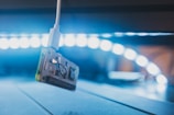 A close-up of a circuit board illuminated by soft blue lighting.