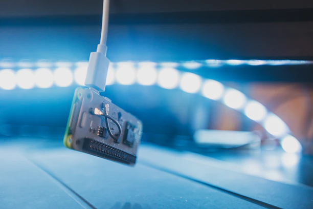 Close-up of futuristic circuit board glowing with blue and silver light.