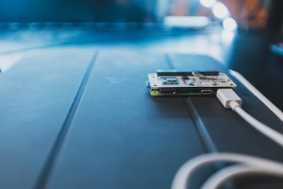 A sleek Arduino board connected to various components, glowing softly under ambient light.