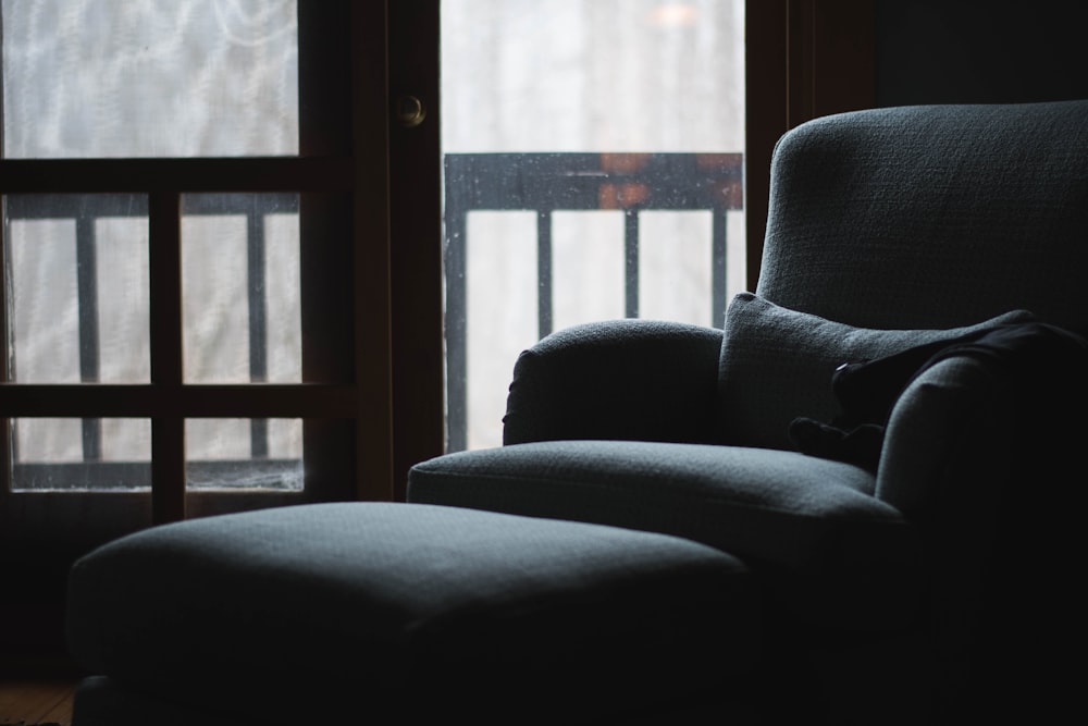 black sofa chair near glass window