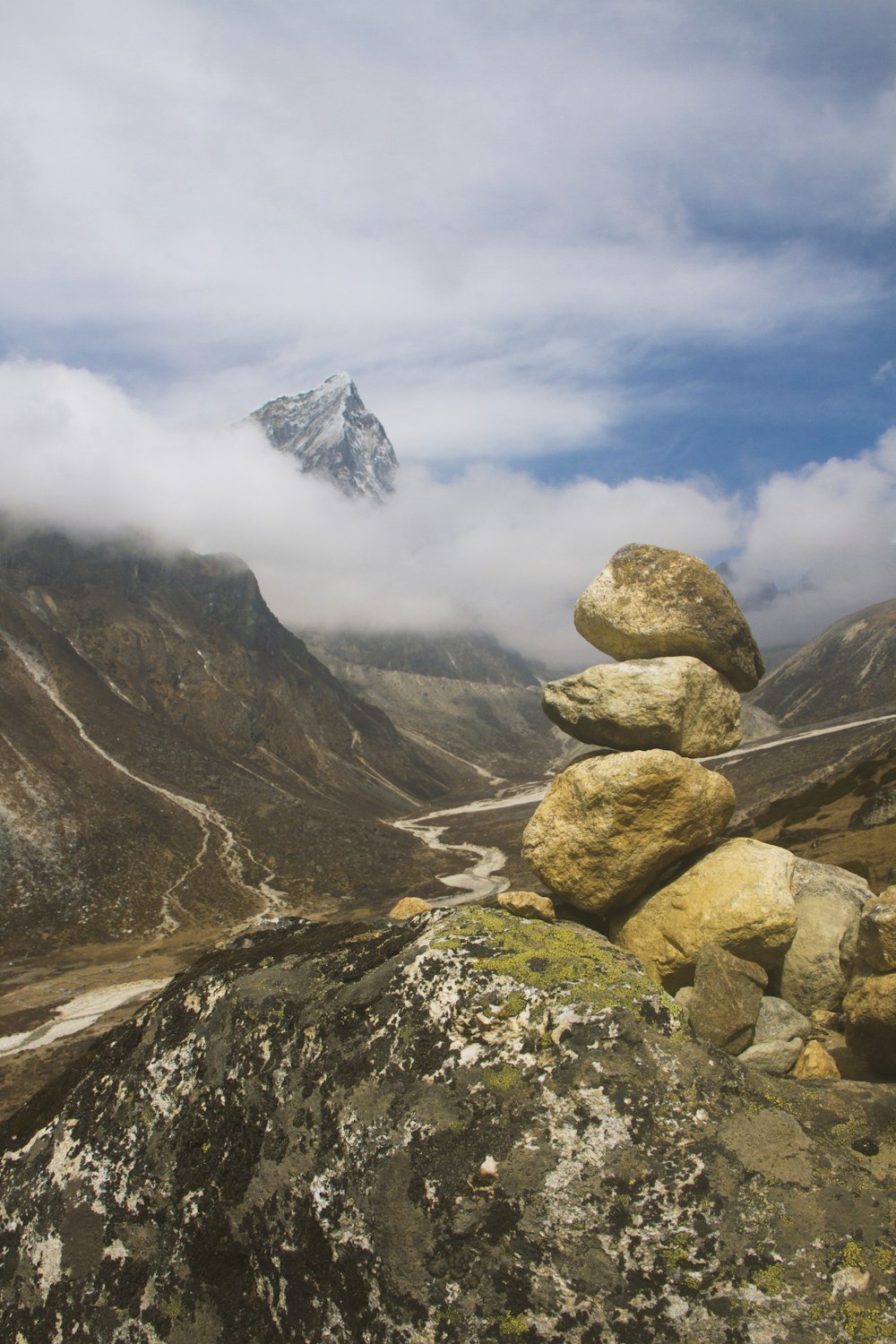 brown rocky mountain under white clouds during daytime