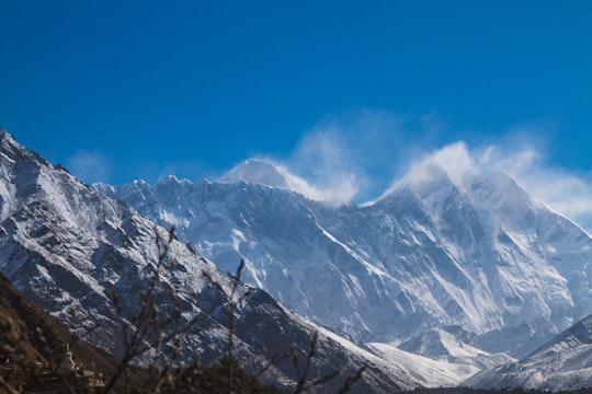 snow covered mountain under blue sky during daytime in Everest Nepal