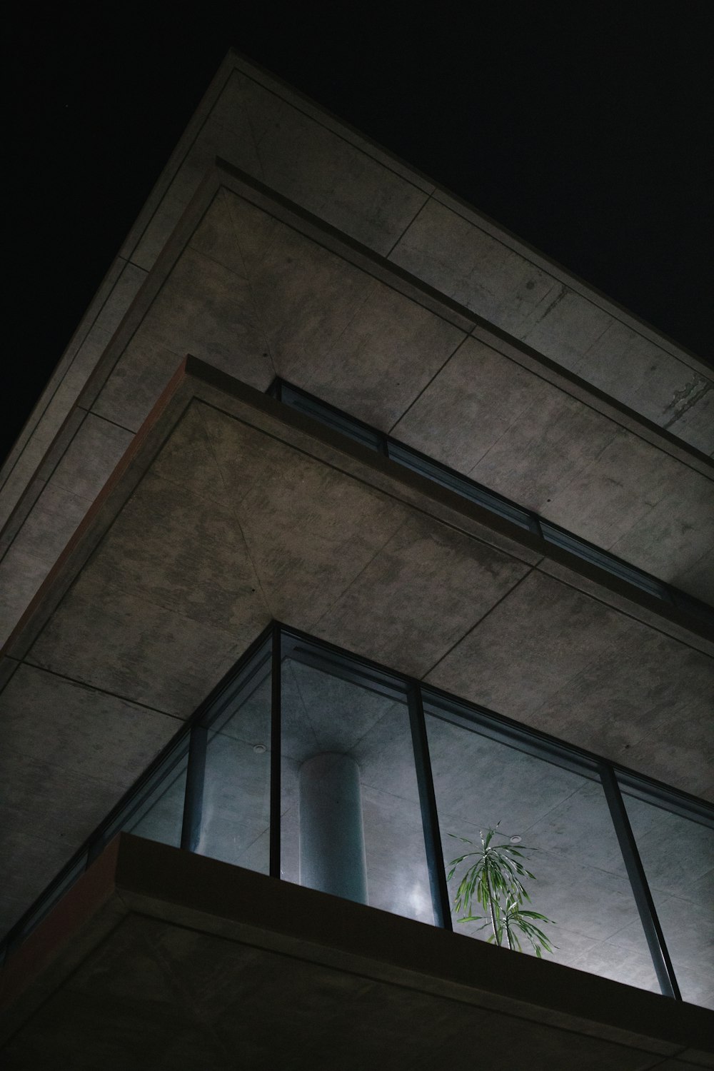 brown concrete building with glass window