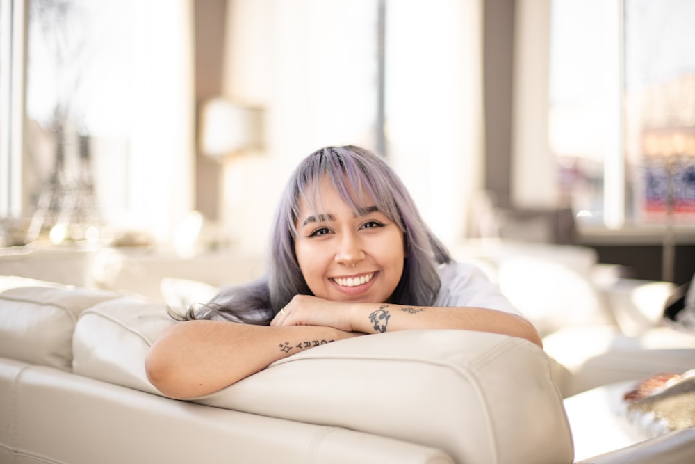 girl in gray shirt lying on white couch