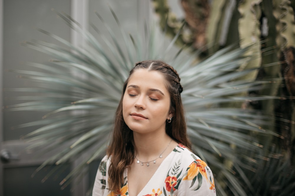 woman in white and orange floral shirt