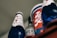 Several beverage containers with diverse labels and designs are arranged, featuring blue and red colors prominently. One bottle has 'Blanc 1664' written on it, and others include a mix of text and abstract designs.