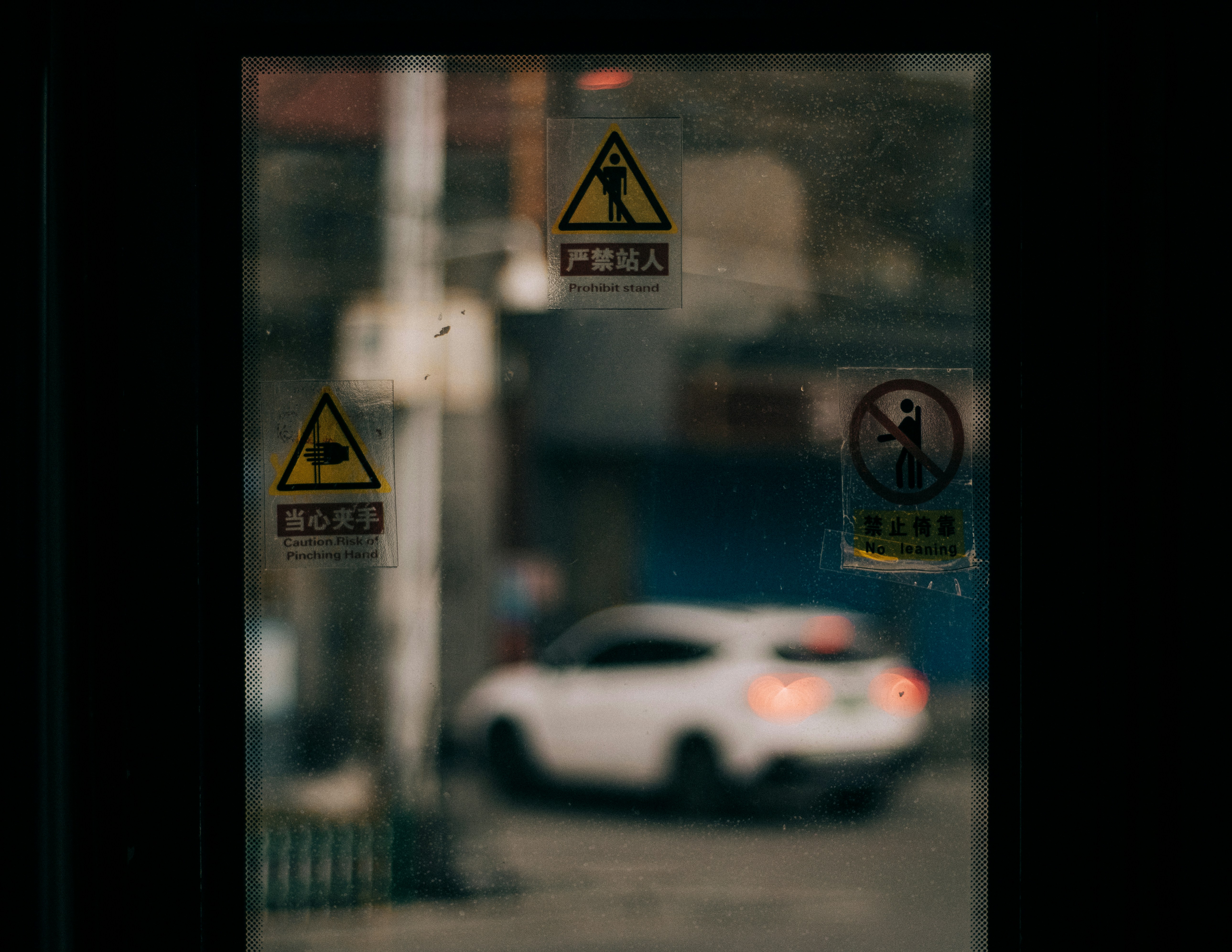 white porsche 911 parked beside glass window