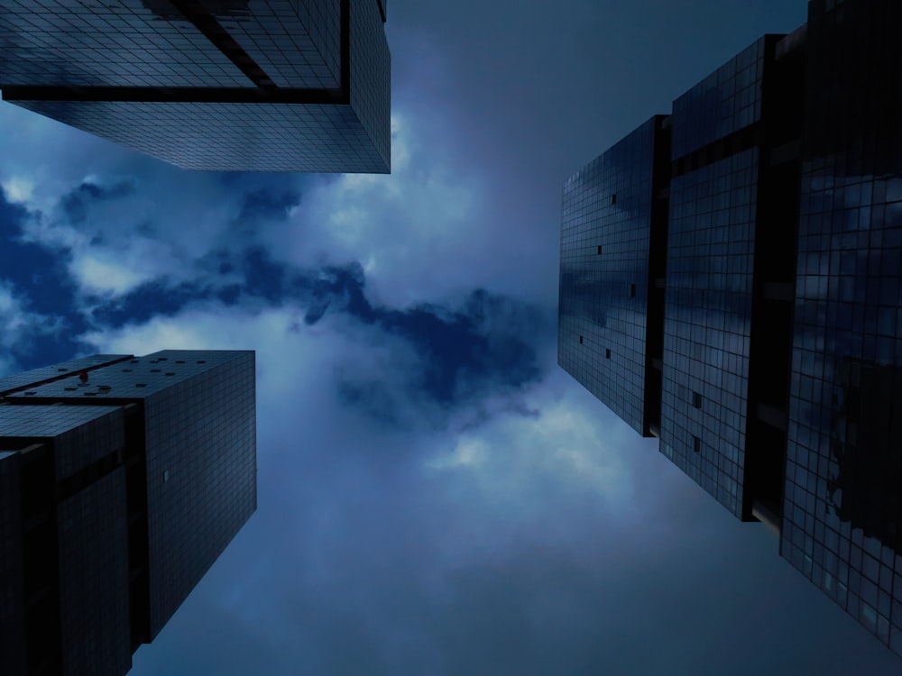 worms eye view of city buildings under cloudy sky during daytime