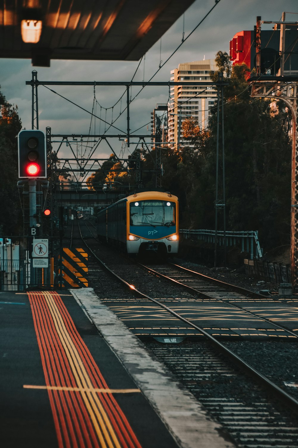 yellow and black train on rail tracks