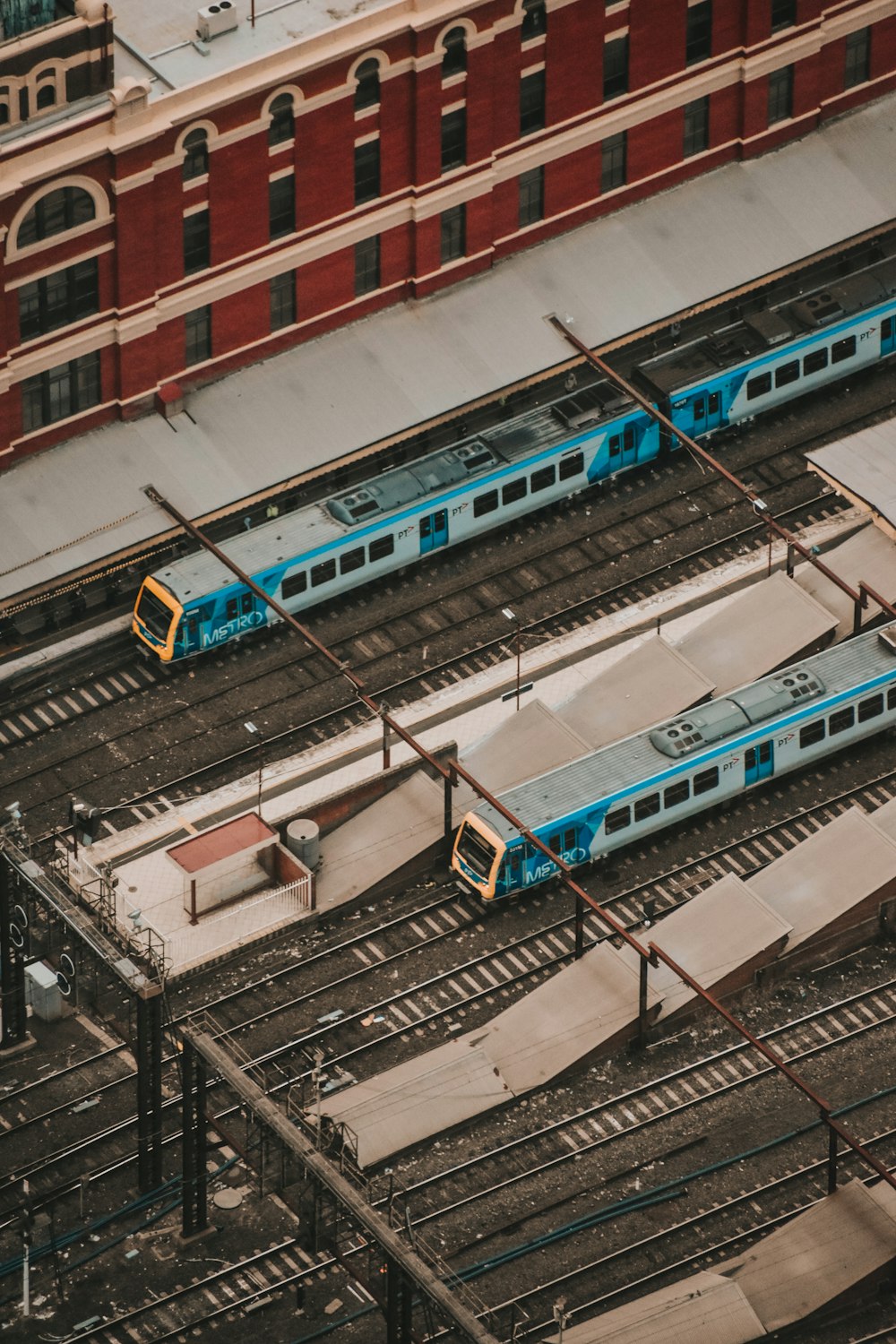 blue and yellow train on rail tracks