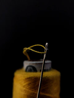 silver safety pin on yellow textile