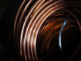 Close-up of stacked copper wire coils in an industrial setting