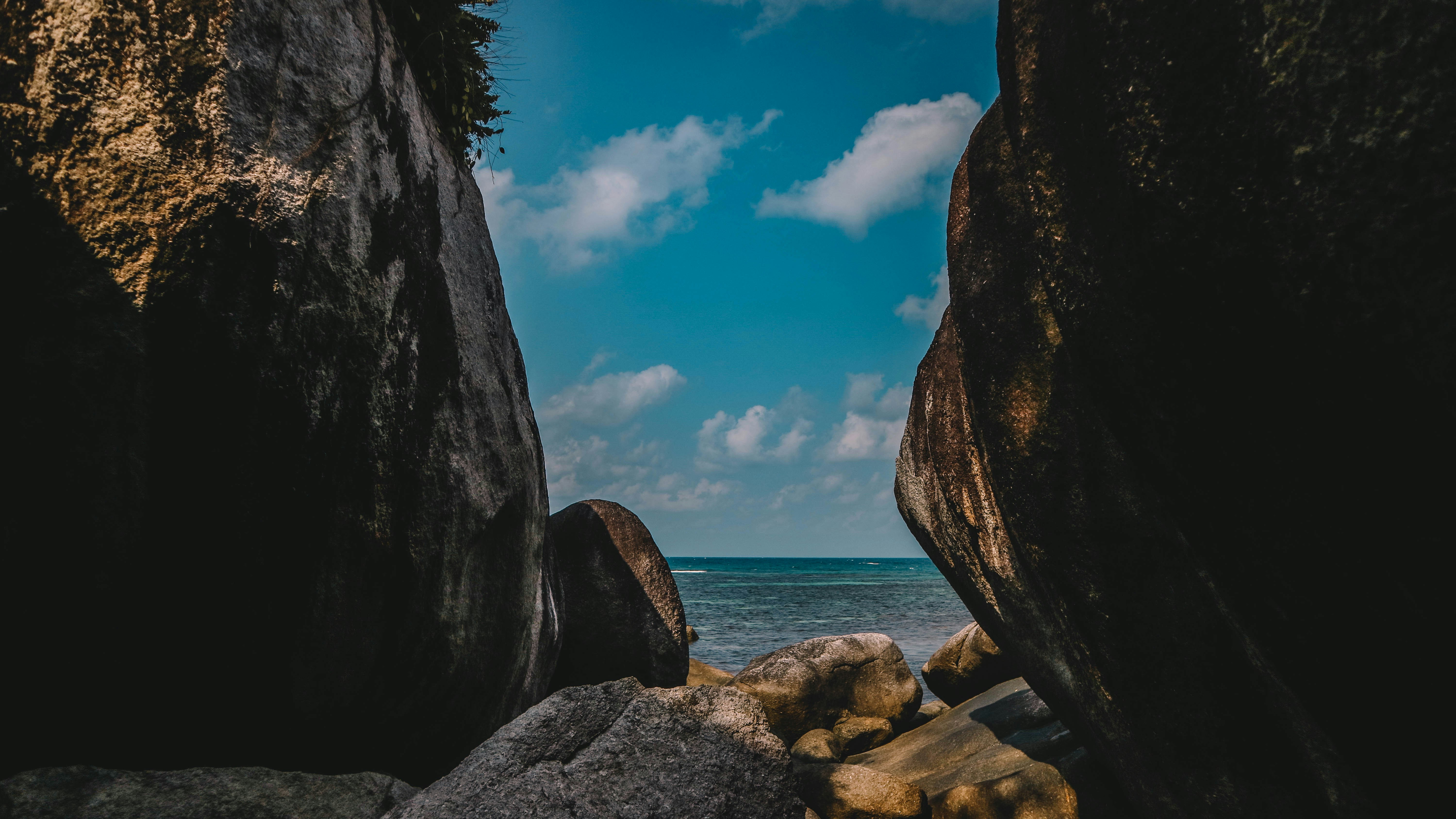brown rock formation near body of water during daytime
