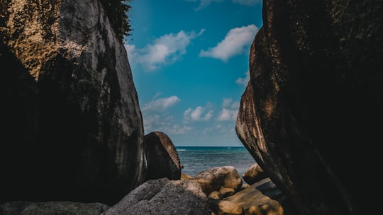 brown rock formation near body of water during daytime in Belitung Indonesia