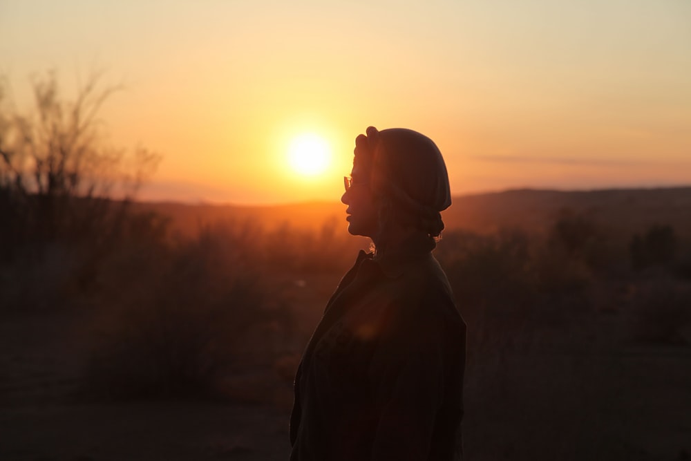 silhouette of man standing during sunset