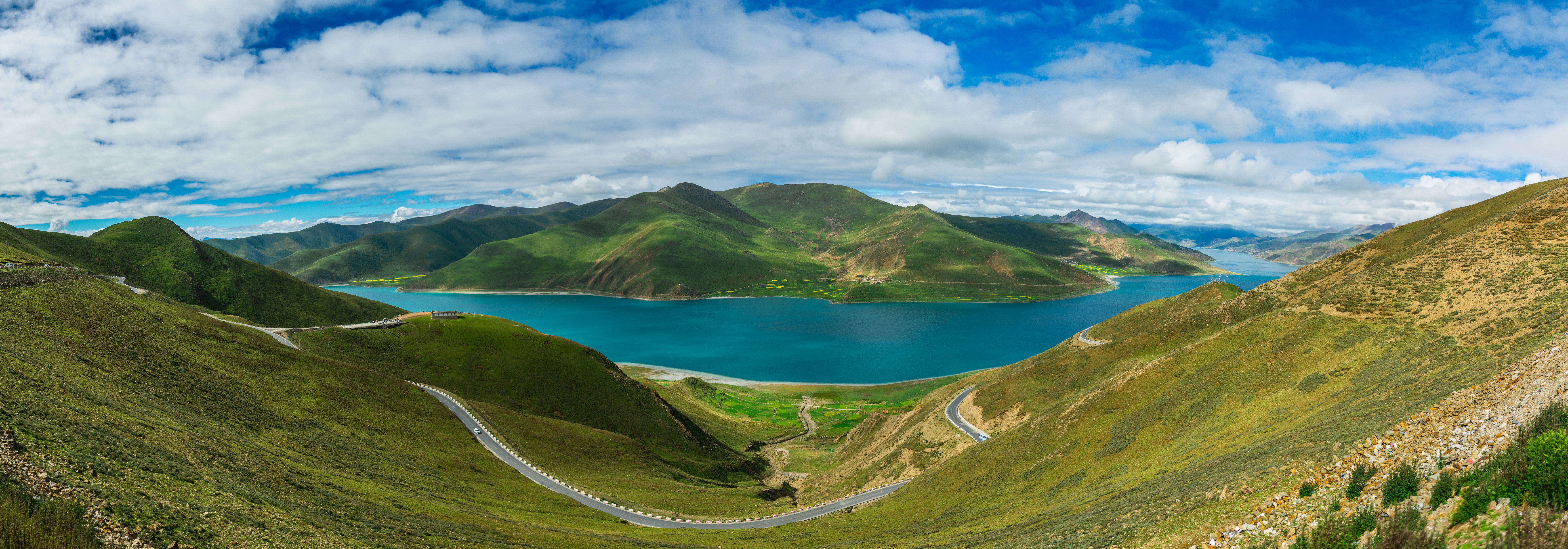 green mountains near body of water under blue sky during daytime, 