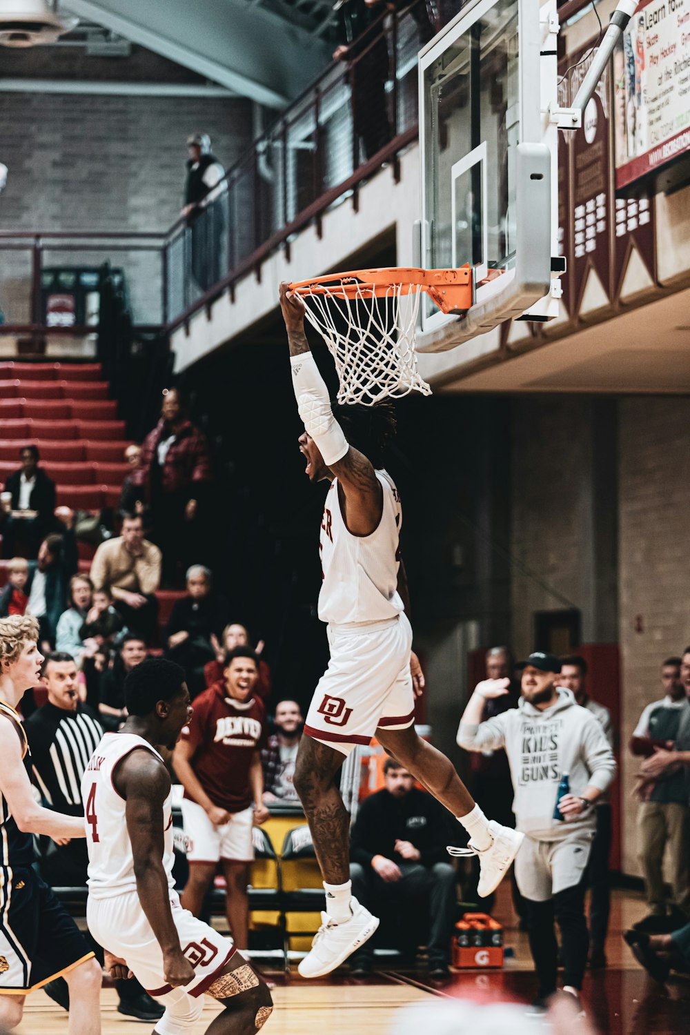 man in white jersey shirt playing basketball