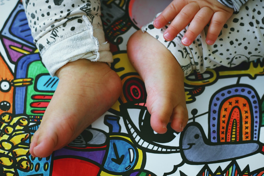 person holding babys foot