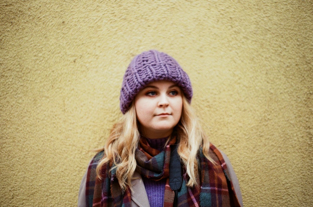 woman in blue knit cap and red and black plaid scarf