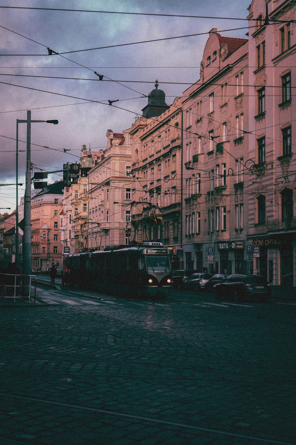 a bus driving down a street next to tall buildings