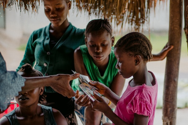 A warm photo of Racheal Davenport with a group of smiling foster youth during a community workshop.