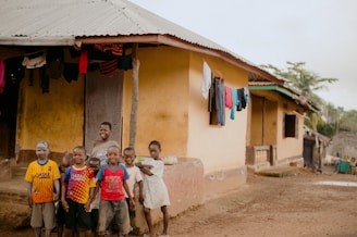 group of people standing near brown concrete building during daytime